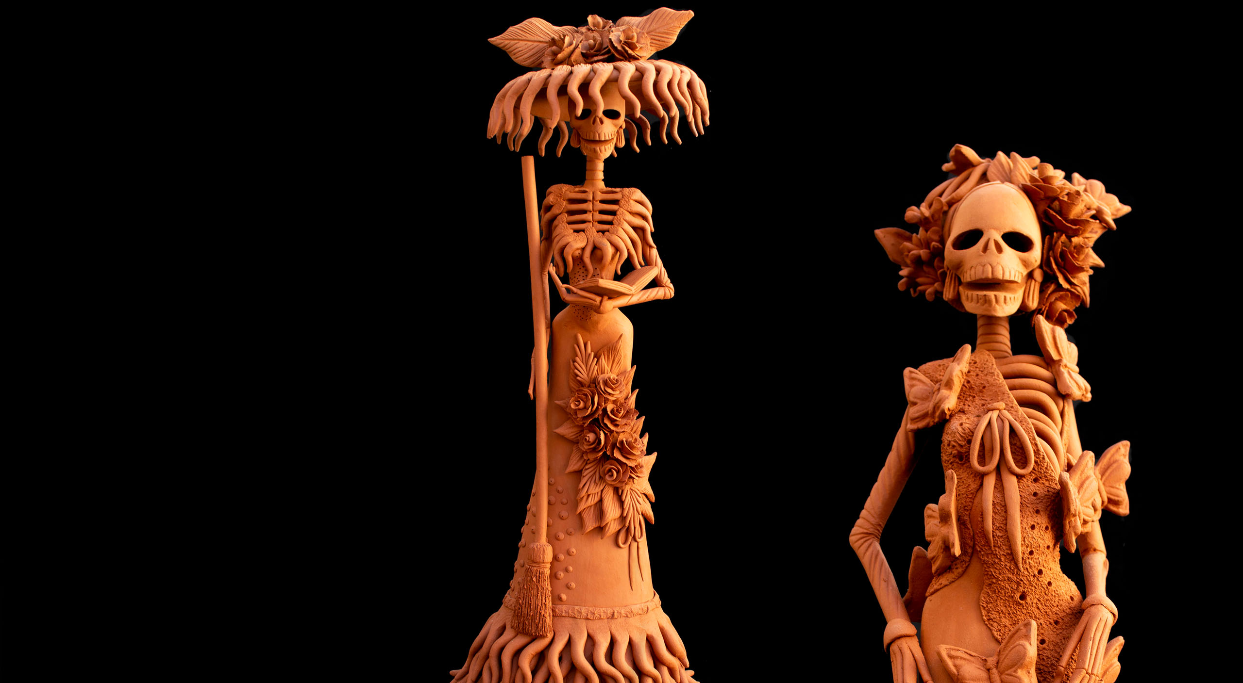 Handmade Catrina figure in traditional Mexican Día de Muertos dress against a black backdrop