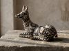 Vibrant Huichol beaded deer skull sculpture covered in intricate multicolour geometric patterns and spiritual symbols